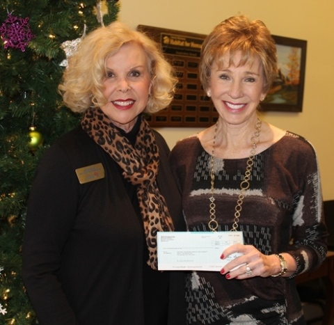 Ann Felton Gilliland (Right), CEO of Central Oklahoma Habitat for Humanity, receives a $5,000 check from Helen Syler on behalf of American Home Shield. Photo by Christi Roney.