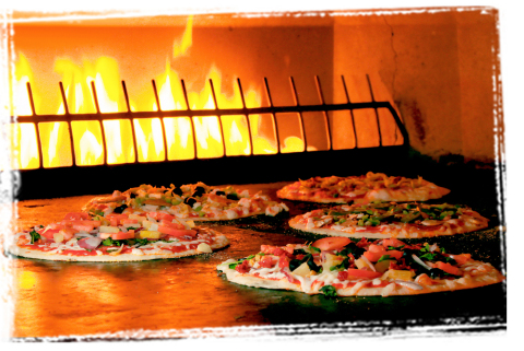 PizzaRev's "Craft Your Own" pizza uses a 900° open-flame stone-bed oven. (Photo: Business Wire)
