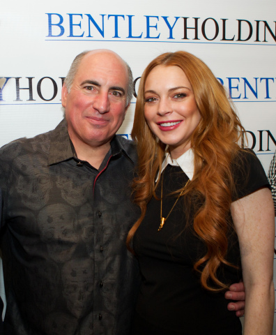 Lindsay Lohan with Cosmo DeNicola at the Futura Mobility Pre-Big Game Party at the Havana Room Cigar Club in NYC on February 1, 2014. Bentley Holdings is Cosmo DeNicola's large enterprise company. (Photo: Business Wire)