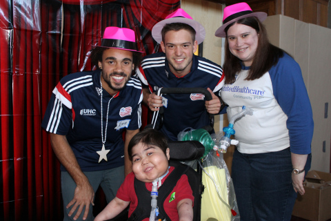 New England Revolution defender Kevin Alston and midfielder Kelyn Rowe pictured with patient of Franciscan Hospital for Children and Cynthia Mailhiot of UnitedHealthcare (Photo: Project Sunshine).