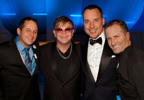 Flanked (l-r) by Crumble Catering's Chris Diamond and Chef Wayne Elias are Sir Elton John and partner David Furnish. From its humble beginnings in 1992, the Elton John AIDS Foundation gala has raised more than $300 million worldwide over the past two decades. (Photo: Business Wire)