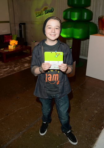 In this photo provided by Nintendo of America, Benjamin Stockham of About a Boy enjoys some hands-on time with the Yoshi's New Island game on the Yoshi-themed Nintendo 3DS system at Quixote Studios in West Hollywood, Calif., on March 9, 2014. The newest game in the Yoshi's Island series launches March 14 for the Nintendo 3DS family of systems. (Photo: Business Wire)