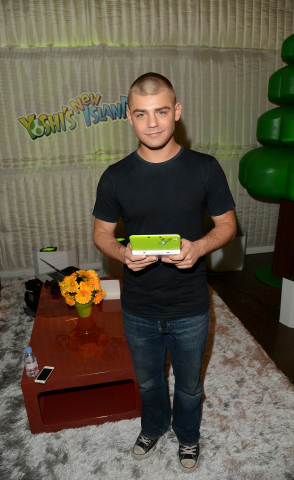 In this photo provided by Nintendo of America, Garrett Clayton of Teen Beach Movie enjoys some hands-on time with the Yoshi's New Island game on the Yoshi-themed Nintendo 3DS system at Quixote Studios in West Hollywood, Calif., on March 9, 2014. The newest game in the Yoshi's Island series launches March 14 for the Nintendo 3DS family of systems. (Photo: Business Wire)
