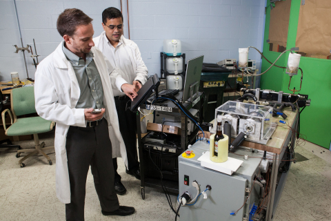 Lead Engineer Michael Benedict (left) and Venkat Venkatakrishnan (right), Director of Advanced Technologies, work in GE Appliances' labs on magnetocaloric refrigeration technology that can replace traditional compressors used in refrigerators for the last 100 years. (Photo: GE)