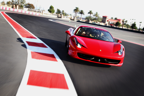 A Ferrari 458 Italia from Exotics Racing drives around the new track at Auto Club Speedway (Photo: Business Wire)