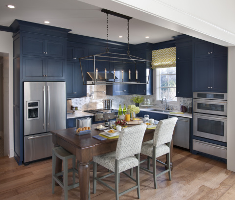 Rough timber elements accent the open kitchen area, where a free floating table stands in for both dining table and kitchen island. Photo (c) 2014 Scripps Networks, LLC.