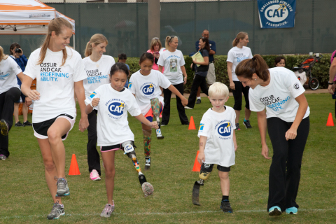 Young challenged athletes learn how to run on their new running legs provided by CAF grants. (Photo: Business Wire)