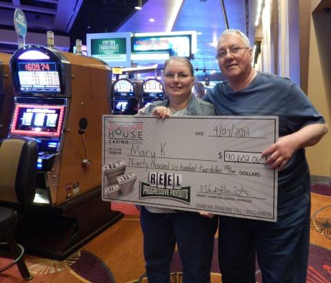 Reel Progressive Payout winner Mary K. and her husband, Charles, pictured with their winnings at SugarHouse Casino. (Photo: Business Wire)