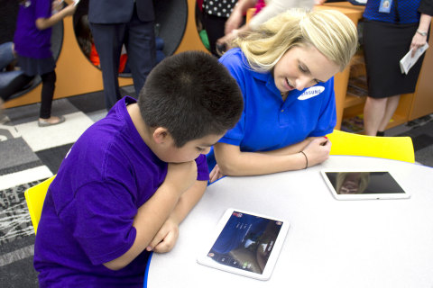 Samsung employee Brittney Pistor, right, interacts with a youth in the Tween Tech Center at Boys & Girls Clubs of Greater Fort Worth on Friday, April 4, 2014. The center is part of a partnership between Samsung Mobile and Boys & Girls Clubs of America to inspire kids' curiosity in STEM. Samsung is creating up to 20 Tween Tech Centers and providing 1200 tablets with custom curriculum applications to select  Boys & Girls Clubs across the country. (Photo: Business Wire)
