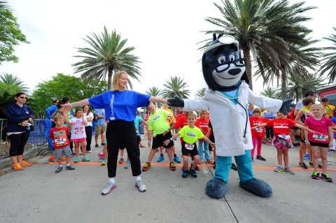 April Golenor, president, UnitedHealthcare Community Plan of Louisiana, and UnitedHealthcare mascot "Dr. Health E. Hound" lead the warm up at today's UnitedHealthcare IRONKIDS New Orleans. Photo Credit: Cheryl Gerber