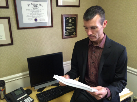 David Howe reviews a report in his office at MCTV (Photo: Business Wire)