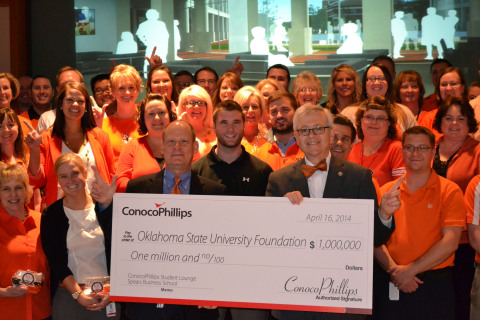 ConocoPhillips announced a $1 million donation toward building a new home for Oklahoma State University's Spears School of Business. During an event in Bartlesville, Okla., Ken Seaman (pictured left holding check), ConocoPhillips' executive sponsor for OSU and a university alum, presented a check for $1 million to OSU's Dr. Ken Eastman (pictured right holding check), interim dean and associate professor of management, Spears School of Business. They are joined by some of the 440 ConocoPhillips employees who are OSU alumni. (Photo: Business Wire)