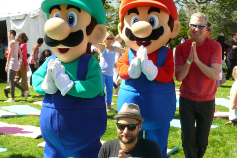 In this photo provided by Nintendo of America, Mario and Luigi join MC Yogi from San Francisco and Roger R. from Houston for a yoga session during the 136th annual White House Easter Egg Roll on April 21, 2014, in President's Park (one of America's 401 national parks!) Nintendo joined with the National Park Foundation to offer guests the opportunity to play Wii Fit U and Wii Sports Club, two active games that align with this year's event theme, "Hop Into Healthy, Swing into Shape," which encourages children and families to live healthier and more active lifestyles. (Photo: Business Wire)