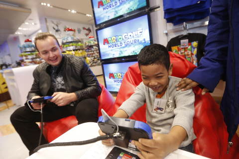 In this photo provided by Nintendo of America, Daniel C., right, of New York, meets celebrity and golf fan Noah Munck during an exclusive media event at Nintendo World on Saturday, April 26, 2014, in New York, where they play against one another in Mario Golf: World Tour for Nintendo 2DS and Nintendo 3DS. Mario Golf: World Tour changes the way golf is played with friends. Instead of waiting to take their turns, up to four players can play through courses simultaneously in local wireless or online matches. (Photo by Jason DeCrow/Invision for Nintendo/AP Images)