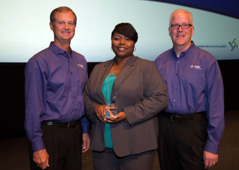 Steve Nieman, senior vice president of Tyler's Local Government Division, and Brett Cate, president of Tyler's Local Government Division, present a Tyler Excellence Award to Dunwoody's Municipal Court Administrator Trina Gallien. (Photo: Business Wire)