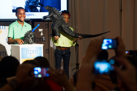 Anthony Hill (L) and Dakota Dunn display toys from the upcoming "Godzilla" movie during the annual TTPM Spring Showcase media event May 1, 2014, in NYC. Hosted by TTPM, a consumer website publishing reviews, videos, and live price updates for all things play, the event highlights the season's best in play for children and their families. (Photo: Business Wire)
