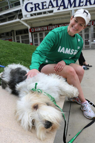Meredith Leslie, of P&G, pets Pawl Griffin, IAMS VP of Canine Communications, as they get ready to run the IAMS Flying Fur dog run in downtown Cincinnati, Sat., May 3, 2014. More than 500 dogs and owners ran in the two-mile race as part of races taking place during the Flying Pig Marathon weekend events. IAMS Bowls of Love will be donating a bag of pet food for each dog running in the event to the SPCA in Cincinnati. (Tom Uhlman/AP Images for IAMS)