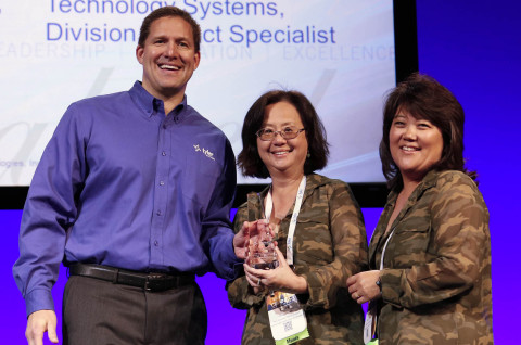 Chris Hepburn, senior vice president of Tyler's ERP & School Division, presents a Tyler Excellence Award to Choy Wong and Kelly Laidley of Contra Costa County Office of Education's Technical Services department. (Photo: Business Wire)