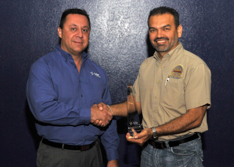 Jorge Cavazos, administrator for information systems at Mission Consolidated Independent School District, accepts a Tyler Excellence Award from Nick Botonis, president of Tyler SIS. (Photo: Business Wire)
