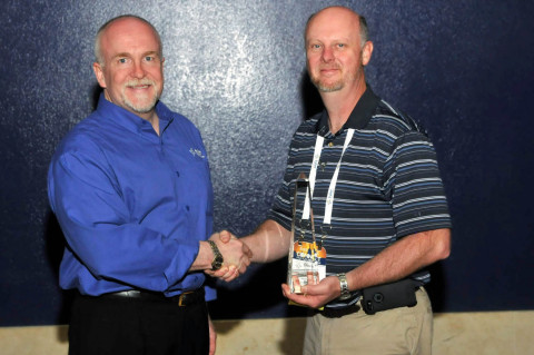 David Pettit, director of transportation of Missouri's Joplin Schools, accepts a Tyler Excellence Award from Ted Thien, senior vice president and general manager of Tyler's Versatrans solution. (Photo: Business Wire)