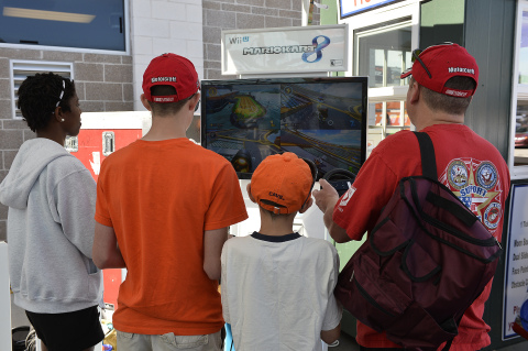 In this photo provided by Nintendo of America, fans gets hands-on time with Mario Kart 8 during an event during the History 300 at Charlotte Motor Speedway in Charlotte, NC on May 24, 2014. Mario Kart 8, the newest installment in the fan-favorite video game series from Nintendo, launches exclusively for Wii U on May 30, 2014. (Photo by Nigel Kinrade)
