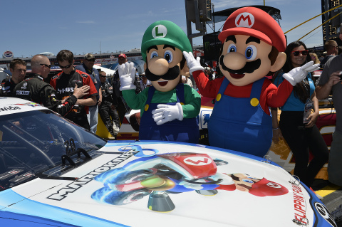 In this photo provided by Nintendo of America, Mario and Luigi conduct one last inspection of the GameStop-sponsored Mario Kart 8 racing car driven by NASCAR driver Matt Kenseth at the History 300 race in Charlotte, NC on May 24, 2014. Launching exclusively for Wii U on May 30, 2014, Mario Kart 8 introduces anti-gravity driving and new power-ups like the Super Horn and Boomerang Flower. (Photo by Nigel Kinrade)