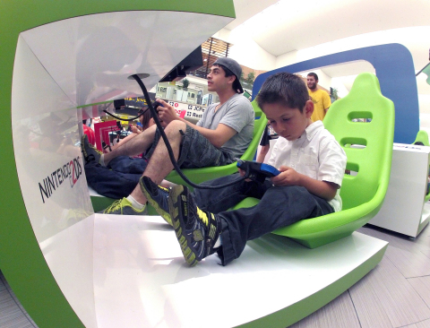 In this photo provided by Nintendo of America and released June 7, 2014, Maxwell H. of Los Angeles races with other attendees in "Mario Kart 7" on Nintendo 2DS at the Westfield Culver City mall on June 6, 2014, as part of the "Play Nintendo Tour 2014." The winners of "Mario Kart 7" competed on a giant HD TV screen in "Mario Kart 8," the new high-definition anti-gravity game for Wii U. The free three-month tour kicked off in Los Angeles and will visit malls and events in a dozen major cities across the United States. (Photo by Nintendo/Bob Riha, Jr.)