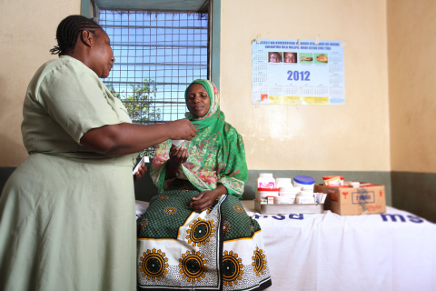 A nurse from a clinic in Dar es Salam District, Tanzania, dispenses medicine to a patient, Optuna John. Since Project Last Mile launched in 2010, Medical Stores Department's distribution system has expanded to include delivery to more than 5,500 health facilities. Previously, Medical Stores Department delivered to approximately 150 district warehouses, thus losing sight of the last mile. Now, people like Optuna can receive medical care that was not readily accessible in the past. (Photo: Business Wire)