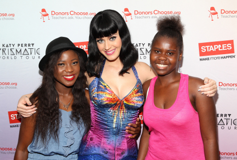 Local students Assima Egbame (left) and  Shavel Proctor (right) backstage at the Verizon Center with Katy Perry after her Prismatic World Tour performance on Tuesday, June 24, 2014, in Washington, DC. As part of its $1 million dollar donation to online charity DonorsChoose.org, Staples, Inc. announced that it has fully funded the balance of every project that was on DonorsChoose.org in the Washington, D.C. community. This $43,994 donation helped 47 teachers fulfill classroom needs and helped more than 3,900 students in the D.C. public school district. Katy Perry teamed up with Staples, Inc. and DonorsChoose.org to 'Make Roar Happen' and support teachers during this back-to-school season. (Photo by Paul Morigi/Invision for Staples/AP Images)
