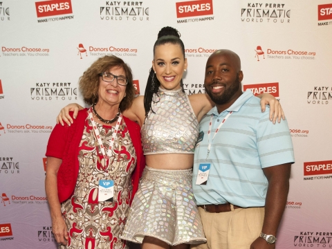 Global pop star Katy Perry with local teachers Pauline Weisz, left, and Matthew Hall, right, backstage at the Philips Arena during her Prismatic World Tour performance on Saturday, June 28, 2014, in Atlanta, GA. As part of its $1 million dollar donation to online charity DonorsChoose.org, Staples announced it has fully-funded the balance of every project on DonorsChoose.org in the Atlanta, GA community. This $128,158 donation helped 77 teachers fulfill classroom needs and helped more than 8,779 students in the Atlanta public school district. Katy Perry teamed up with Staples and DonorsChoose.org to "Make Roar Happen" and support teachers during this back-to-school season. (Photo by Dan Harr/Invision for Staples/AP Images)