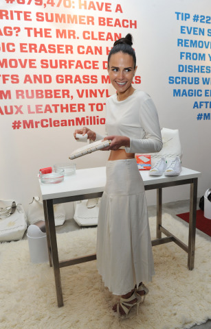 Actress Jordana Brewster uses the Magic Eraser on her white clutch at the Mr. Clean Summer Fashion party, Tuesday, July 1, 2014, in New York. The event, hosted by stylist Brad Goreski, showcased that there are about a million uses for the famed Magic Eraser, including those in fashion, beauty and beyond. (Diane Bondareff/Invision for Mr. Clean)