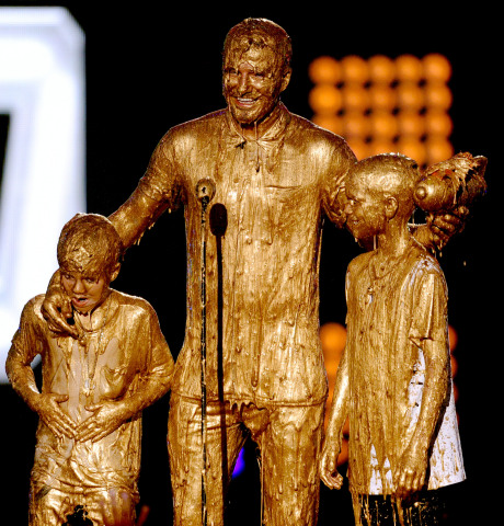 Photo credit: Kevin Winter/Getty Images Soccer player David Beckham (C) with Cruz Beckham (L) and Romeo Beckham (R) get slimed onstage during Nickelodeon Kids' Choice Sports Awards 2014 at UCLA's Pauley Pavilion on July 17, 2014 in Los Angeles, California
