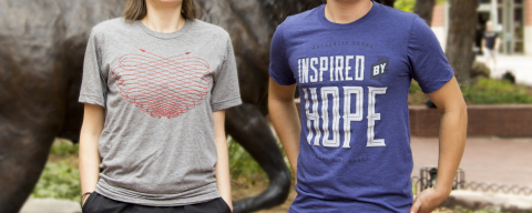 The two winning IMM-designed (http://imm.com/) shirts chosen by MaxLove: “Inspired by Hope” and “Heart.” Both t-shirts are available at the MaxLove Brand website (http://www.givemaxlove.org/) with all net proceeds going to the MaxLove Project. (Photo: Business Wire)