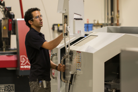 Tomas Garces, community manager, adjusts the axis on the Haas CNC Lathe in the FirstBuild lab, which offers all the tools community members need to bring their ideas to life. (Photo: GE)