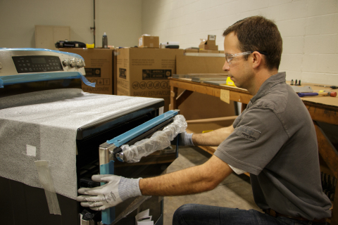 Chris Naber, design engineer, works on building the easy-slide oven door in the FirstBuild micromanufacturing space. The top oven cavity features an ergonomically designed door that slides out like any cabinet drawer in your kitchen, making it easy to retrieve your meal. (Photo: GE)