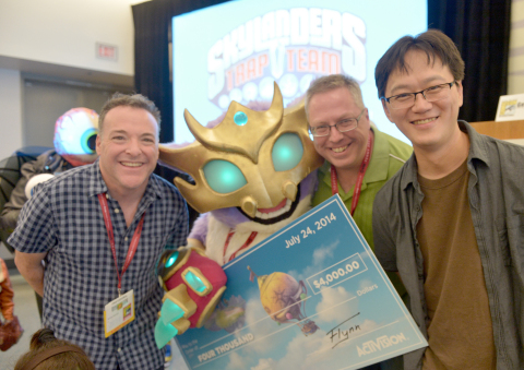 In this photo distributed by Activision Publishing Inc., Skylanders fans celebrate the upcoming launch of Skylanders Trap Team by participating in a costume contest at San Diego Comic-Con 2014 on July 24, 2014 in San Diego, California. Shannon Deeds (2nd L), who beat out other contestants for the ultimate prize and bragging rights of being the best costumed character, Scratch, poses with (L-R) famed voice of Kaos Richard Horvitz, renowned comic book writer Ron Marz and Toys for Bob's Director of Toy and Character Development I-Wei Huang. (Photo by Charley Gallay/Getty Images for Activision)