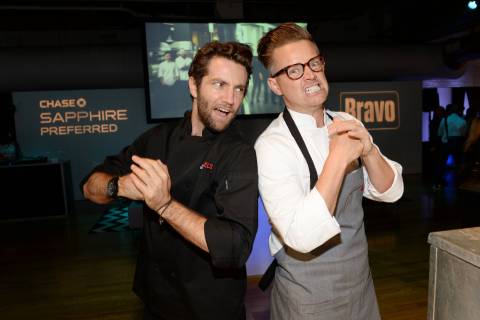 Rival chefs Marcel Vigneron, left, and Richard Blais participate in the "Top Chef Duels" Premiere Tasting Event, hosted by Chase Sapphire Preferred and Bravo, at the Altman Building, on Monday, Aug. 4, 2014 in New York. (Photo by Evan Agostini/Invision for Chase Sapphire Preferred/AP Images)