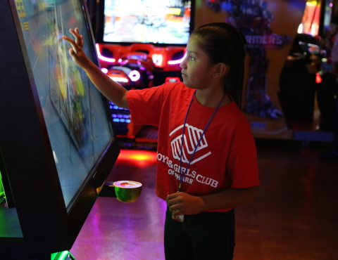 Photo courtesy of PharrNOW. To celebrate its first location in The Rio Grande Valley, Main Event Entertainment provided a sneak preview of its new center and a charitable gift of $5,000 to the Boys & Girls Club of Pharr on August 5. Shown here, Alondra Navarro enjoys a touch-screen game called Fruit Ninja, one of hundreds of video games located throughout the 58,000 square-foot facility. (Photo: Business Wire)