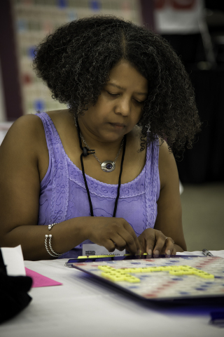 Lisa Odom from St. Louis Park, MN plays during the 2014 National SCRABBLE Championship at the Buffalo Niagara Convention Center, Wednesday August 13. Odom, the highest ranking female in Division 1, placed 12th at the tournament which gathered over 500 global players. (Photo: Business Wire)