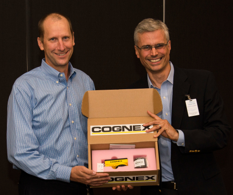 Cognex Corporation CEO Robert Willett delivers the company's one millionth shipment to Ron Wilson, Medtronic VP of Operations and GM, Tempe Campus. (Photo: Business Wire)
