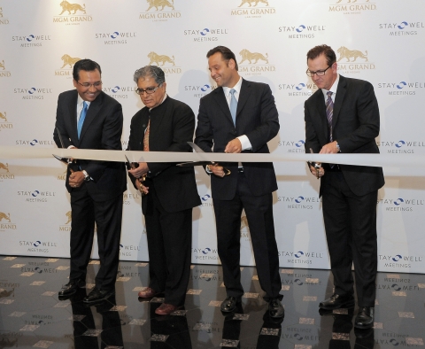 Dr. Deepak Chopra leads ribbon-cutting for the launch of Stay Well Meetings by Delos at MGM Grand Las Vegas. From left to right: Senior Vice President of Sales for MGM Resorts International, Mike Dominguez; Dr. Deepak Chopra; Delos Founder Paul Scialla; and President and COO of MGM Grand, Scott Sibella. (Photo: Business Wire)