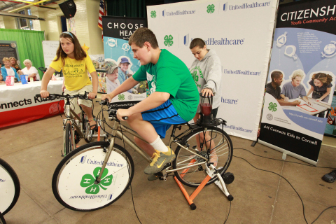 4-H Youth Health Ambassadors Zaia Ivan from Greene, N.Y. (left), and Nate Edwards from Morris, N.Y. (center), create their own smoothies using pedal power at the annual New York State Fair in Geddes, near Syracuse, on Aug. 21. The smoothie bikes are part of 4-H and UnitedHealthcare's partnership called "Eat4-Health," which helps tackle obesity by promoting healthy eating and lifestyles among youth and families (Photo: Michael J. Okoniewski for UnitedHealthcare).