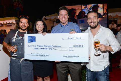 Chef Ray Garcia, left, Lauren Furgione, Vice President of Chase Sapphire, Michael Flood, President and CEO of Los Angeles Regional Food Bank, and Chef Fabio Viviani are awarded a $20,000 donation for Los Angeles Regional Food Bank at the Chase Sapphire Preferred Chef Challenge during the Ultimate Bites of L.A. at the Los Angeles Food & Wine Festival, presented by FOOD & WINE, on Thursday, Aug. 21, 2014 in Los Angeles. (Photo by Evan Agostini/Invision for Chase Sapphire Preferred/AP Images)
