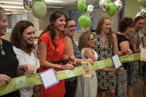 Accolade employees celebrate the opening of the company's Scottsdale office by cutting a ribbon decorated with thank you notes and kind words from clients. (Photo: Business Wire)