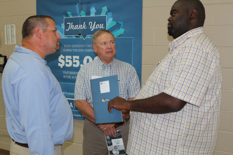 (AUGUST 22, 2014) Terrence Davis (right), Executive Director, Boys and Girls Club of Hopkinsville-Christian County, and Dave Fernandez (center), the organization’s chairman of the board, talk with Ryan Dixon, Production Operator, U.S. Smokeless Tobacco Co. (USSTC), an Altria company, at a recent ACECF check presentation in Hopkinsville, Ky.