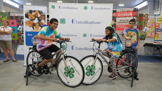 Kevin Perez, Jodi Morales, Heydy Benitez, and Noah Beedles - 5th graders from Platte Valley Elementary School in Grand Island - create their own healthy smoothies on the UnitedHealthcare and 4-H smoothie bike at the Nebraska State Fair Thursday, Aug. 28, in Grand Island, Neb. The healthy-smoothie bikes are part of 4-H and UnitedHealthcare's "Eat4-Health" partnership aimed at tackling obesity by promoting healthy eating and lifestyles among children and families (Video by Chad Greene).