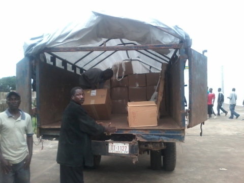 ChildFund International workers in Liberia unload emergency medical supplies delivered by humanitarian airlift to help contain the spread of the Ebola virus. (Photo: Business Wire)