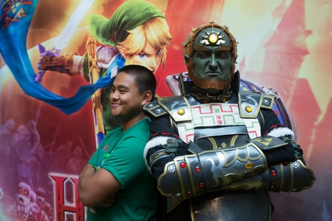 In this photo provided by Nintendo of America, from left, Uyq Nguyen poses with Andrew Hosking, dressed as Ganondorf, at an off-site event during PAX Prime 2014 on Saturday Aug. 30, 2014 in Seattle. Attendees dressed in themed cosplay or exclusive branded T-shirts had the opportunity to enter to win a piece of original concept art from the upcoming Wii U game Hyrule Warriors. (Photo by STEPHEN BRASHEAR/Invision for Nintendo/AP Images)