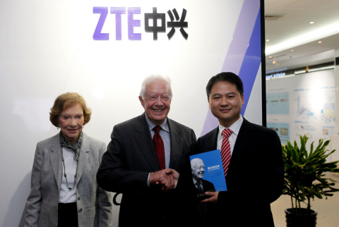 President Carter presents his book, A Call to Action, to ZTE Executive Vice President Adam Zeng (Photo: Business Wire)