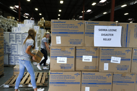 Project C.U.R.E. volunteers prepare urgently needed exam gloves and medical supplies for shipping to healthcare workers fighting the Ebola outbreak in West Africa. Mundelein, Ill.-based Medline Industries, Inc. donated more than 330,000 exam gloves that will be distributed to hospitals in Sierra Leone, Liberia and Guinea. (Photo: Business Wire)